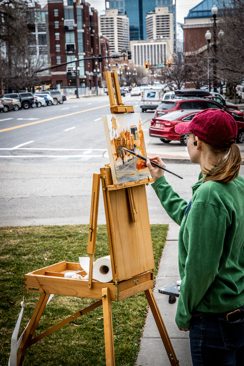 Image of artist painting during Urban Plein Air event