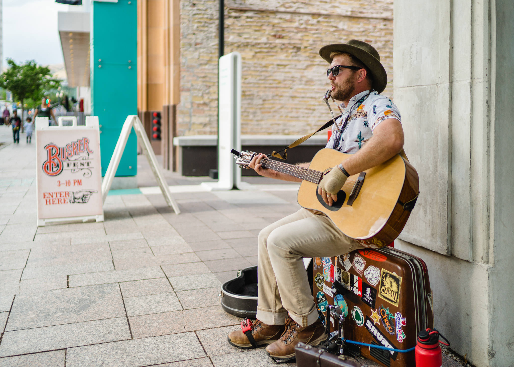 Busker/Street Performer playing his guitar on the sidewalk